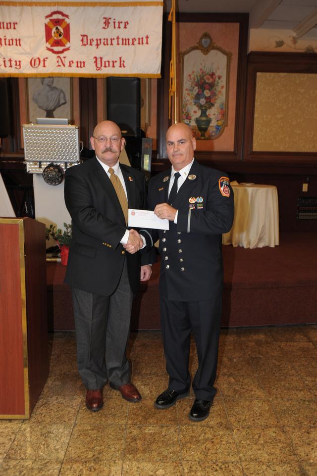 NY State Honorary Fire Chiefs
President Michael Hill presents a donation check to President Paul Mastronardi